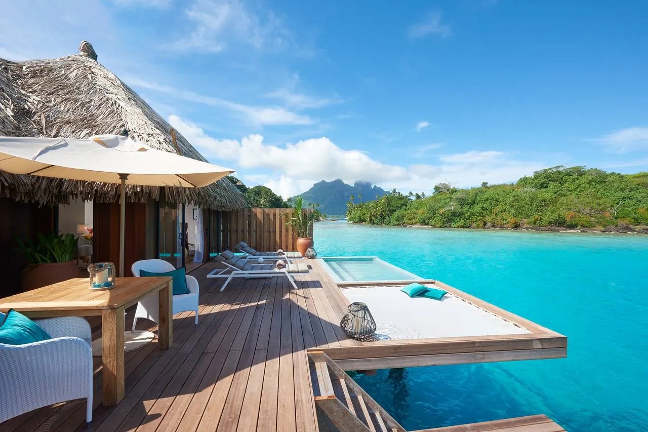 Bora Bora overwater bungalow beside turquoise water